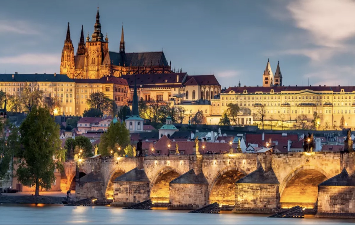 Prague Castle and St. Vitus Cathedral above the Charles Bridge at dusk